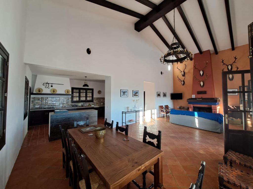 sala de estar con mesa de madera y chimenea en Casa Rural Alberquillas, en La Puebla de los Infantes