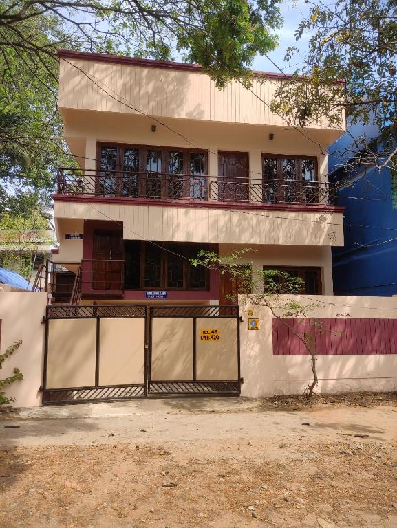 a house with a gate in front of it at Sreevalsam Guest House in Trivandrum