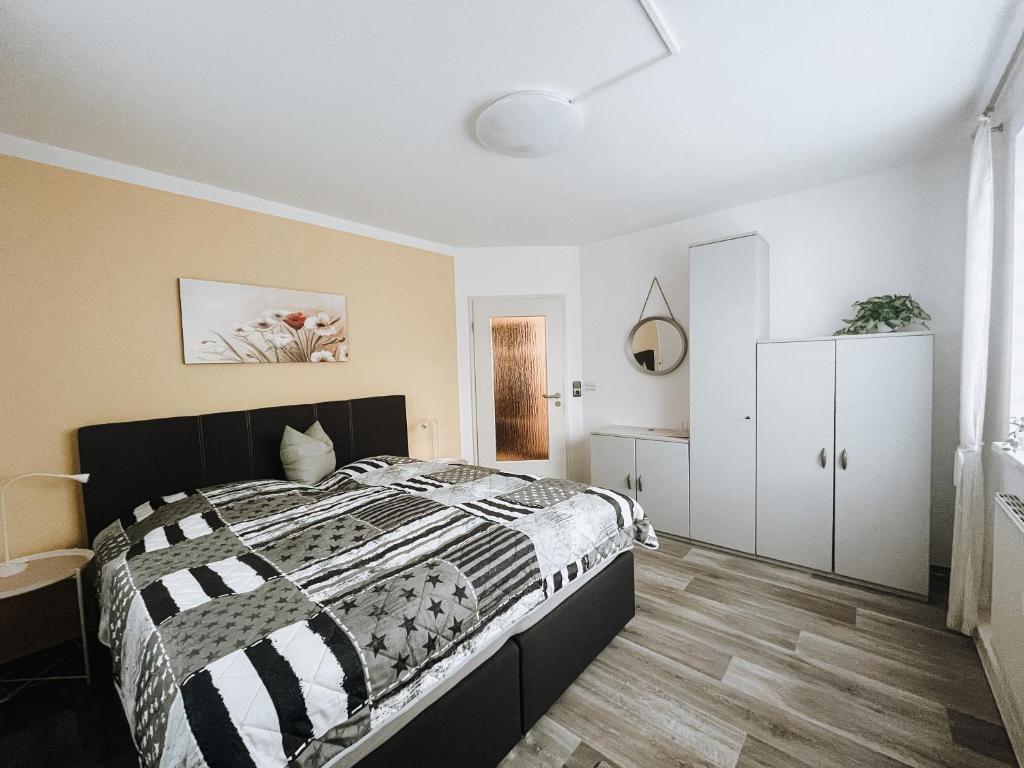 a bedroom with a bed with a black and white comforter at Ferienwohnung zum Schreckenberg in Annaberg-Buchholz