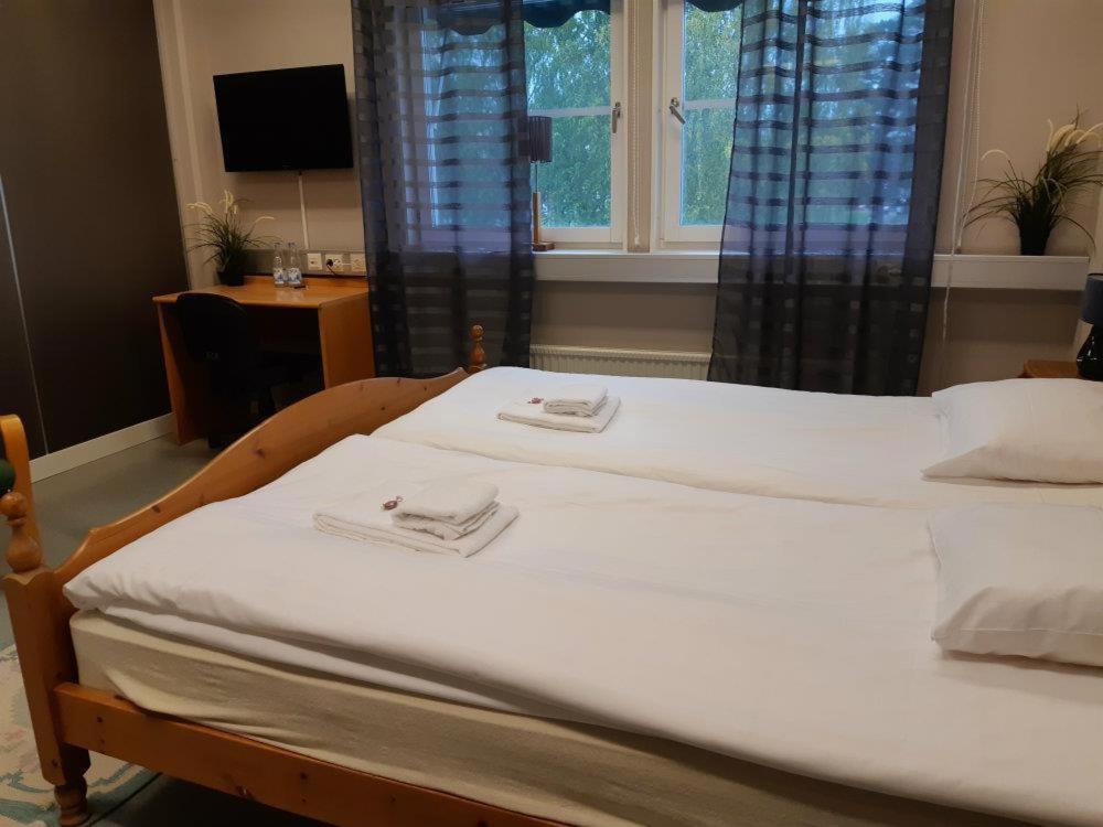 a large bed with two towels on top of it at Monicas Bed&Breakfast in Hagfors