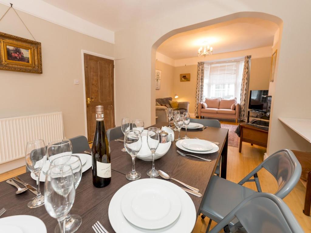 a dining room with a table with wine glasses at Pass the Keys 3 Storey Townhouse in Shrewsbury