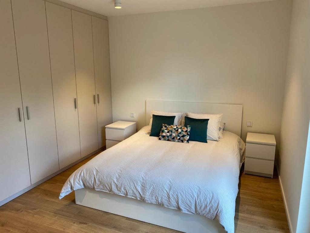 1 dormitorio con 1 cama blanca y armarios blancos en Adorable Apartment City Center with Parking, Near Tram, en Luxemburgo