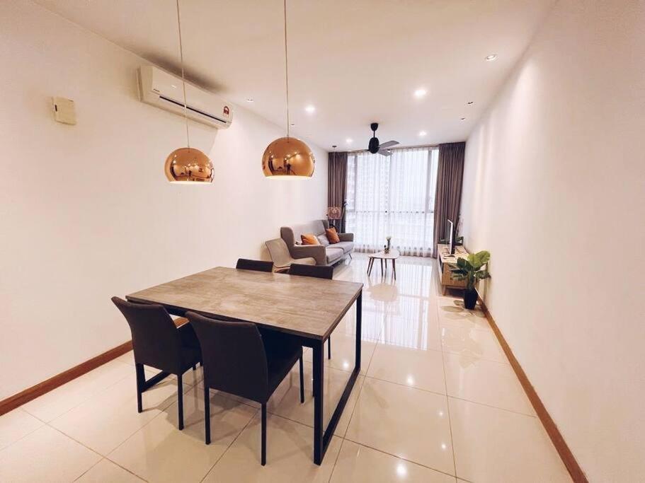 a living room with a dining room table and chairs at [PROMO]Connected train 2 Bedroom ABOVE MALL (22) in Kuala Lumpur