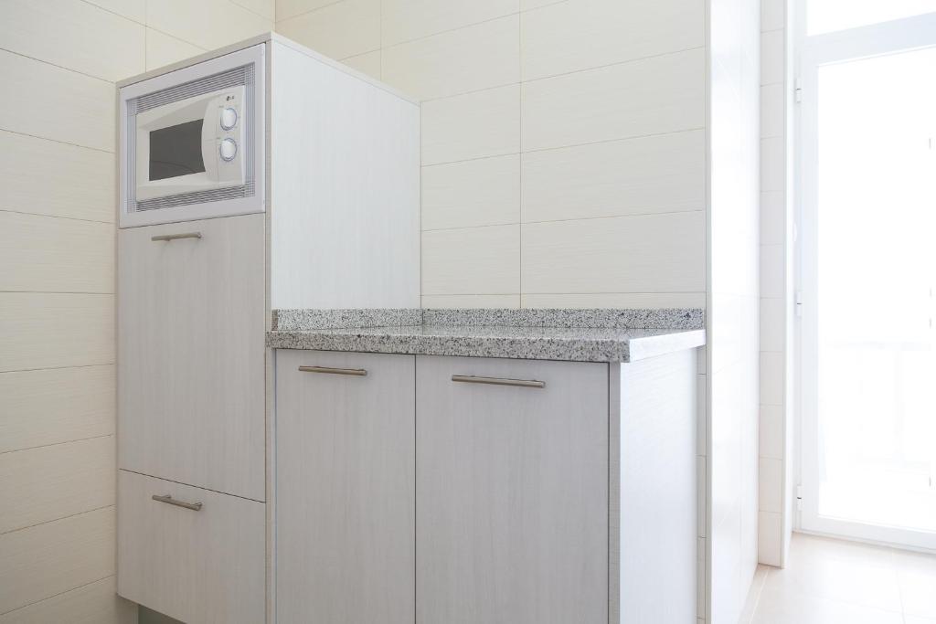 Kuchyňa alebo kuchynka v ubytovaní UHC COSTA PINOSMAR APARTMENTS