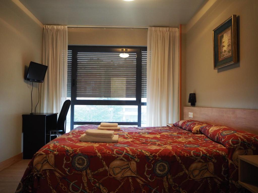 Postel nebo postele na pokoji v ubytování Hostal Acella