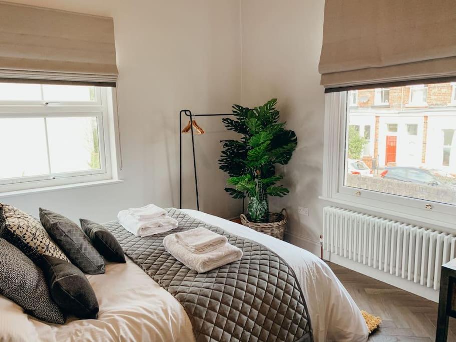 a bedroom with a bed with two towels on it at The Garden Room in York