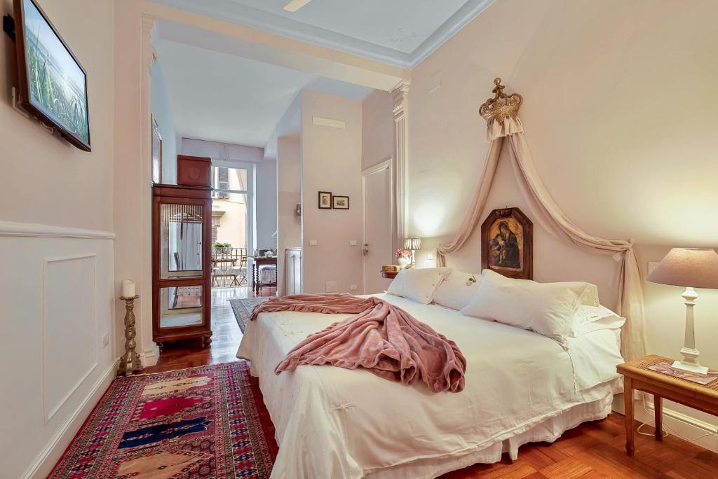 a bedroom with a large bed with a canopy at Suite Royal in La Spezia