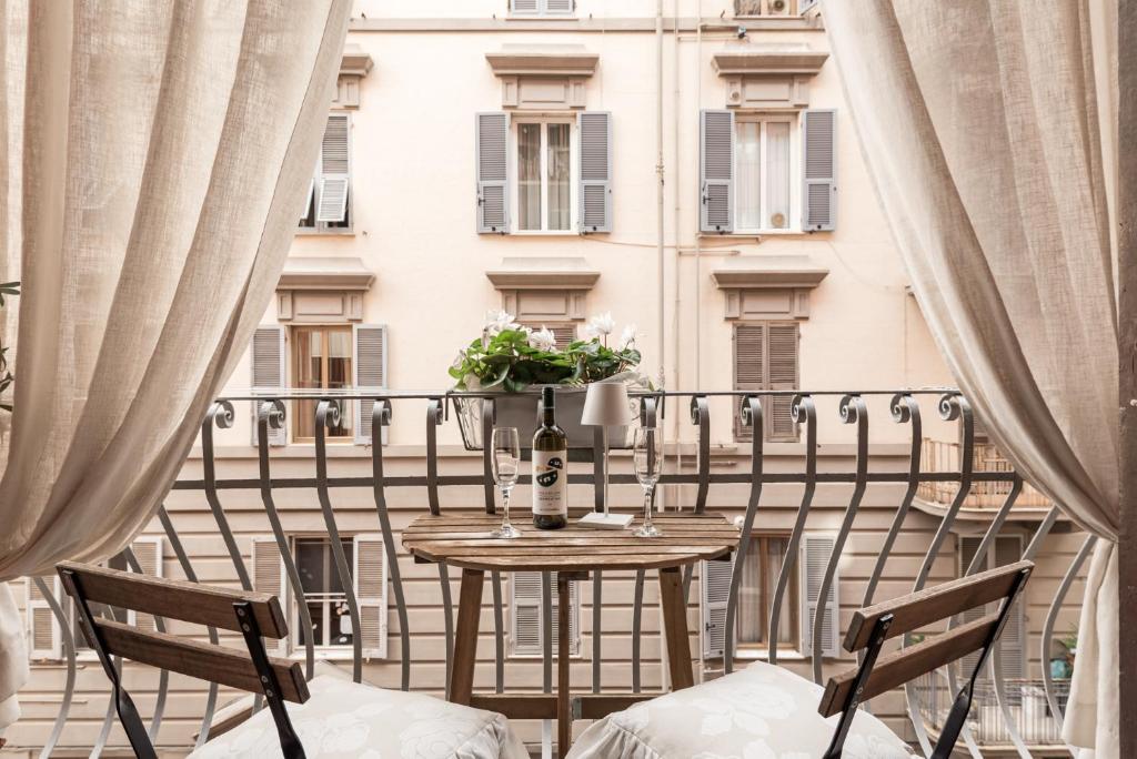 a table on a balcony with a view of a building at Suite Royal in La Spezia