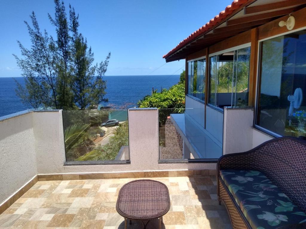 Cette maison dispose d'un balcon avec vue sur l'océan. dans l'établissement Farol House, à Maricá