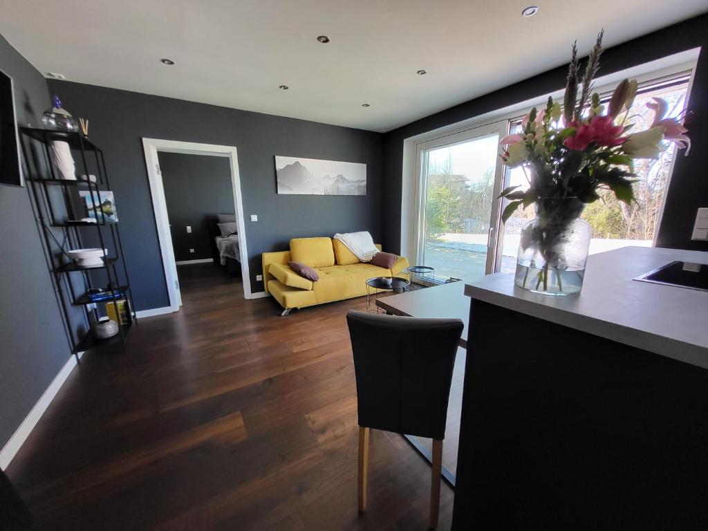 a kitchen and living room with a yellow couch at Quartier4 in Sonthofen