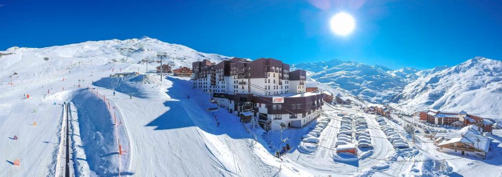 a building on top of a snow covered mountain at Villages Clubs du Soleil - LES MENUIRES in Les Menuires