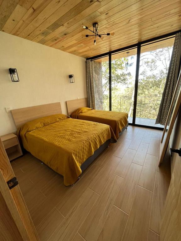 Postel nebo postele na pokoji v ubytování Cabaña La Finca Mazamitla