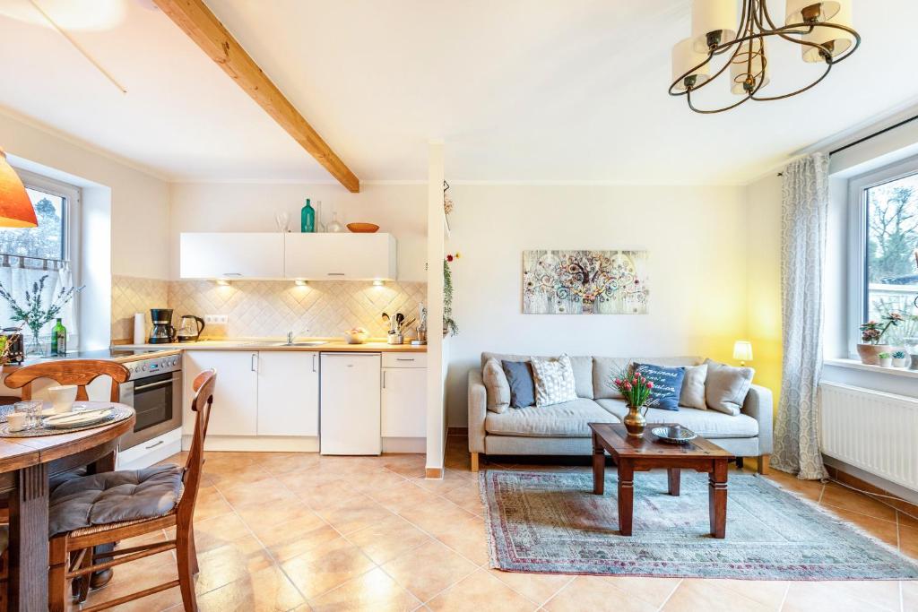 a kitchen and living room with a couch and a table at Ferienwohnung an der Schlei in Fleckeby