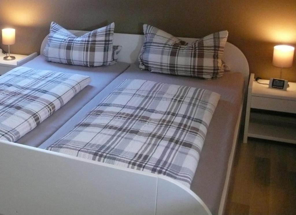 two beds with plaid pillows on them in a room at Ferienwohnung Andrea in Rust