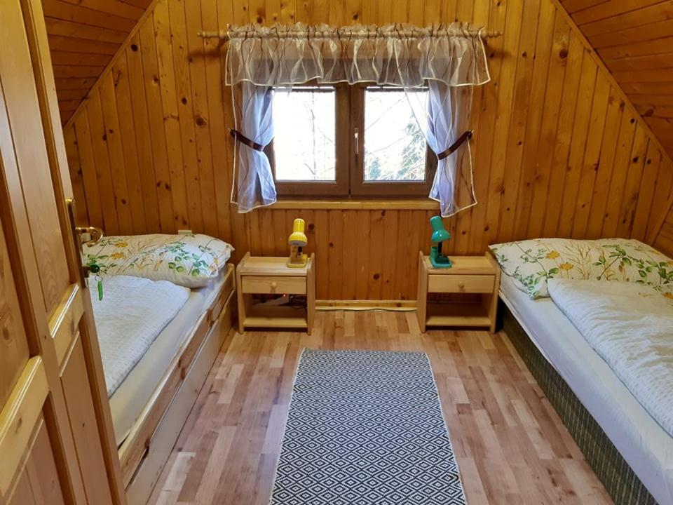 A bed or beds in a room at Chata Klaudia