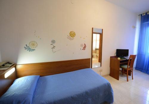 Postel nebo postele na pokoji v ubytování Hotel Astor