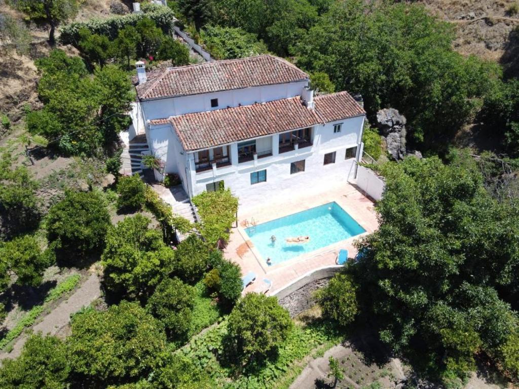 an aerial view of a house with a swimming pool at Finca Riolavar in Jubrique