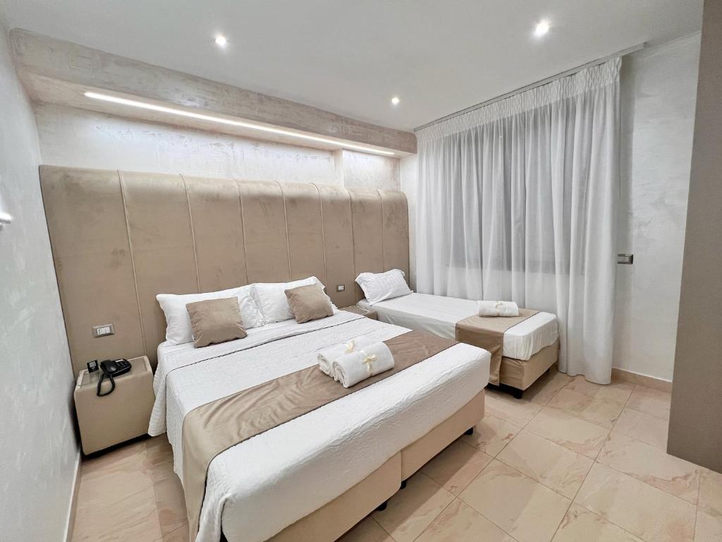 Postel nebo postele na pokoji v ubytování Hotel Paradiso