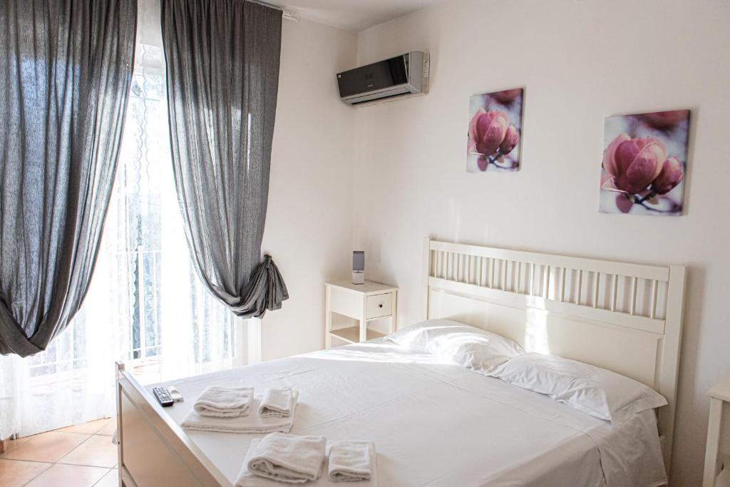 a bedroom with a white bed and a window at Gambero Nero in Tellaro