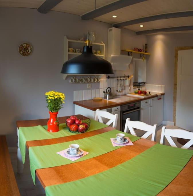 a kitchen with a table with a green table cloth at Dom Sielski w Górach Stołowych in Radków