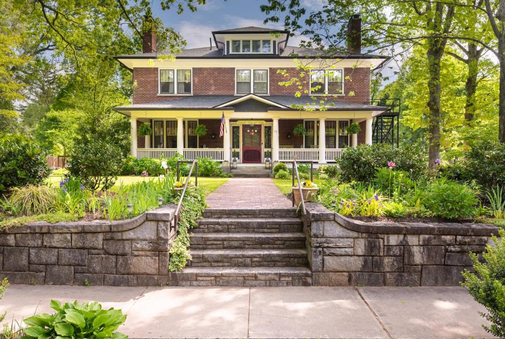 a brick house with a stone stairway in front of it at Sweet Biscuit Inn in Asheville