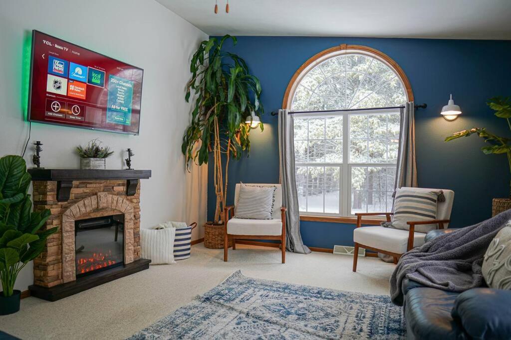a living room with a fireplace and a window at Steve's Sweet Spot - UP Adventure Getaway in Silver City