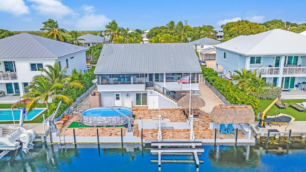 an aerial view of a house with a swimming pool at Tavernier Keys Home w/70’ Dock & 20k Boat Lift on Bayside! 3/2.5 Plus Game Room in Tavernier