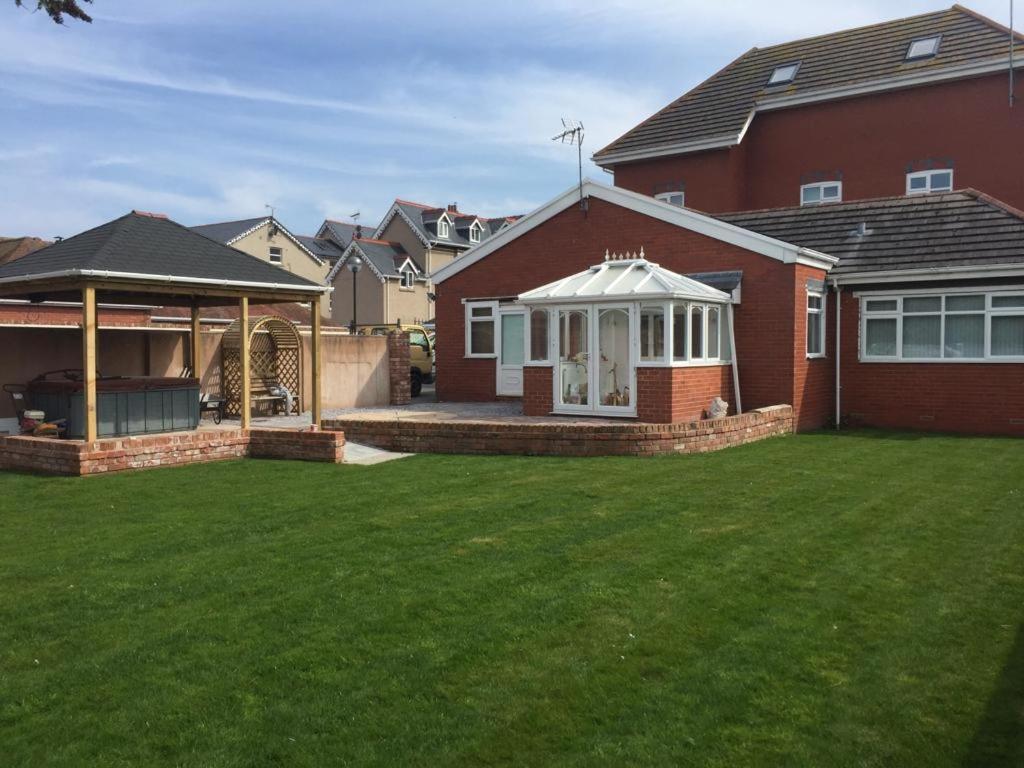 a backyard of a house with a gazebo at Cederee in Rhyl