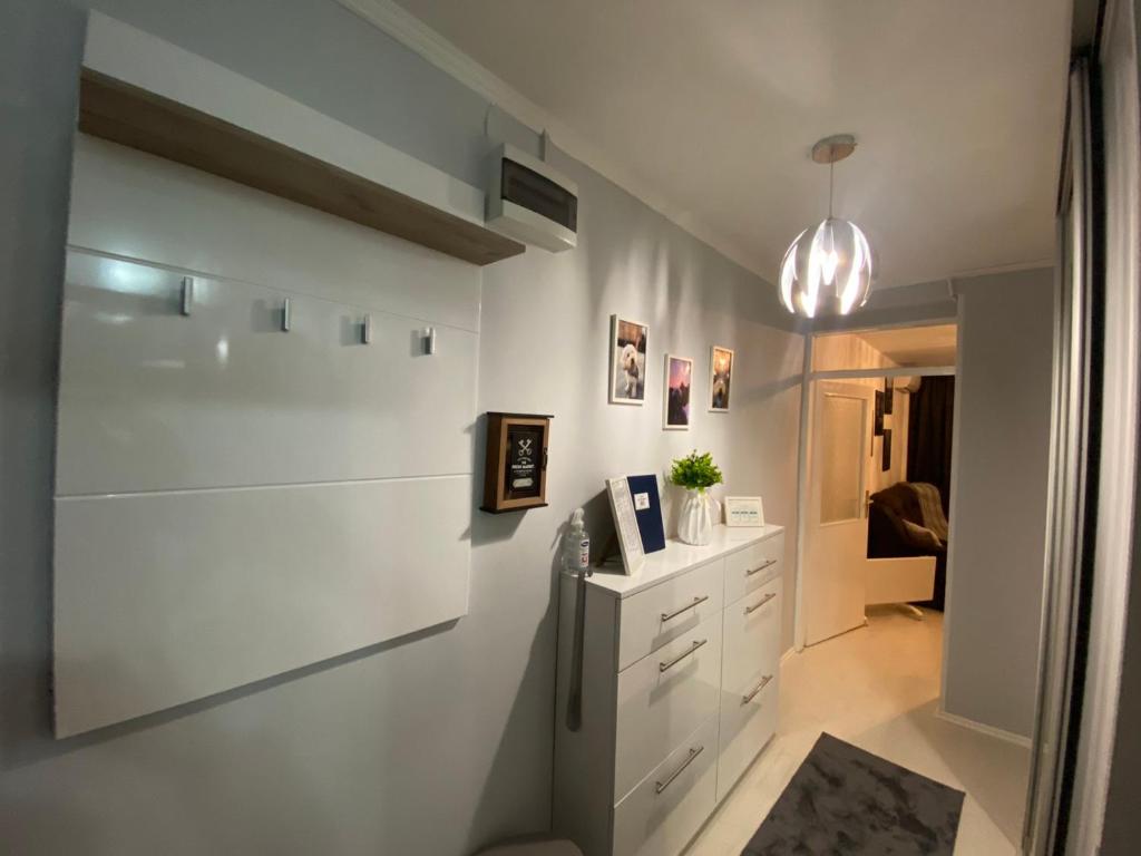 a kitchen with white cabinets and a refrigerator at Apartman Kali in Banja Luka