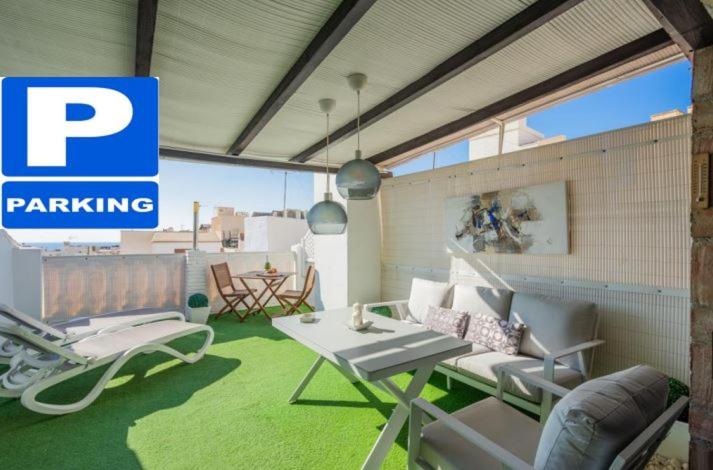 a patio with a table and chairs and a parking sign at Sunny Studio Nerja in Nerja