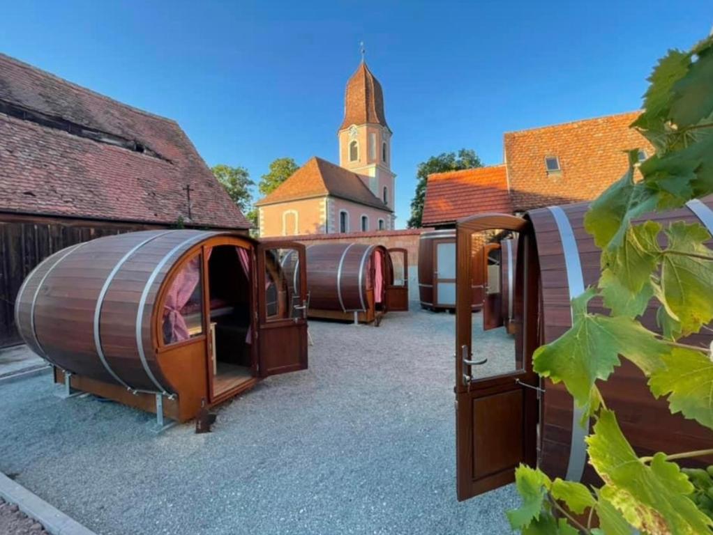 a group of domes parked next to a building at Schlafen im Weinfass in Ipsheim