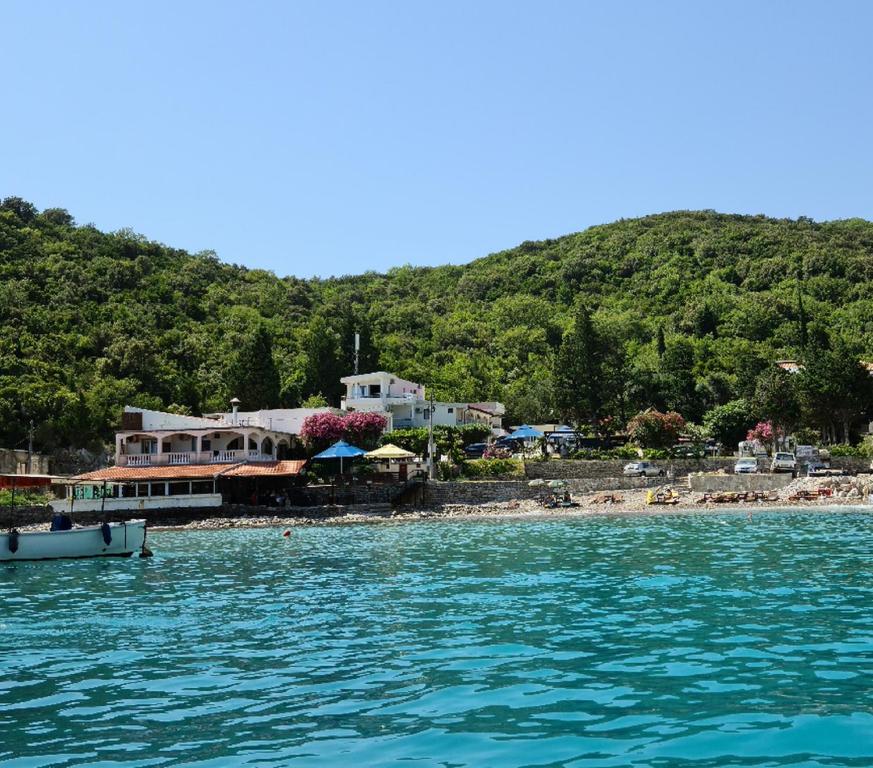 a boat in the water next to a beach at Apartment AS in Čanj