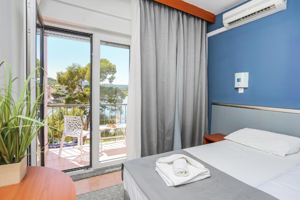 Кровать или кровати в номере Hotel Lumbarda