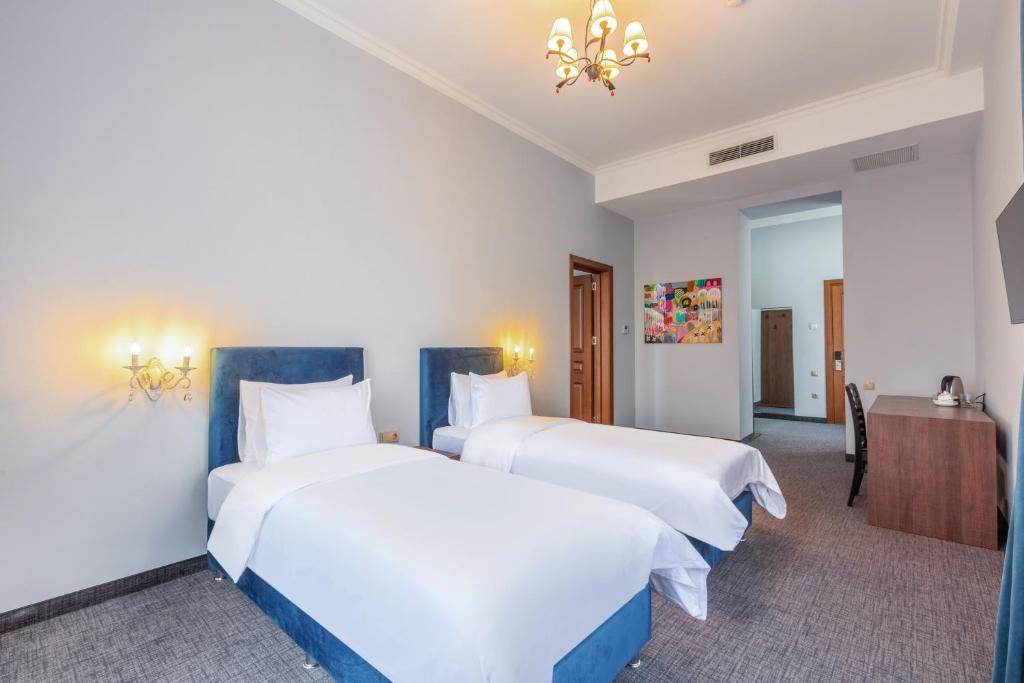 Postel nebo postele na pokoji v ubytování Alma Boutique Hotel