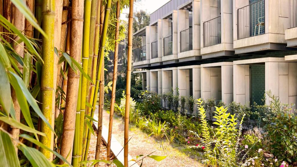 a row of bamboo poles in front of a building at Jardim da Batalha Boutique Hotel by Shiadu in Porto