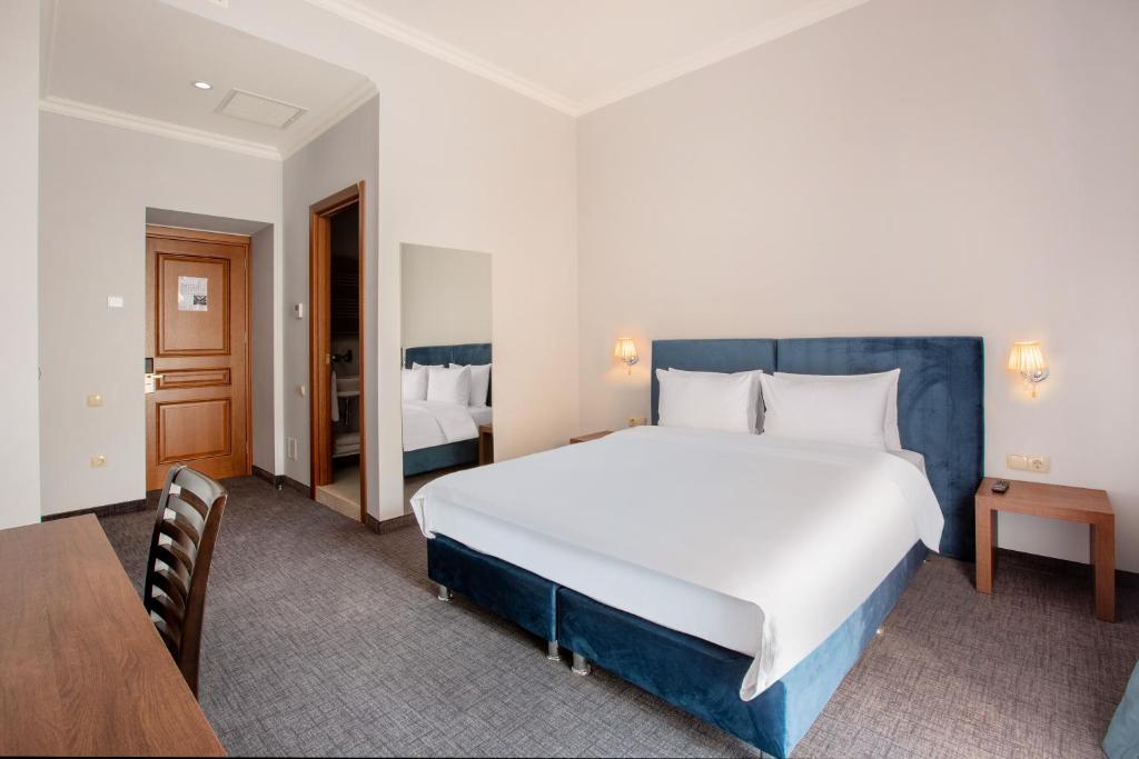 Postel nebo postele na pokoji v ubytování Alma Boutique Hotel