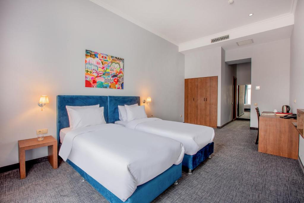 Postel nebo postele na pokoji v ubytování Alma Boutique Hotel