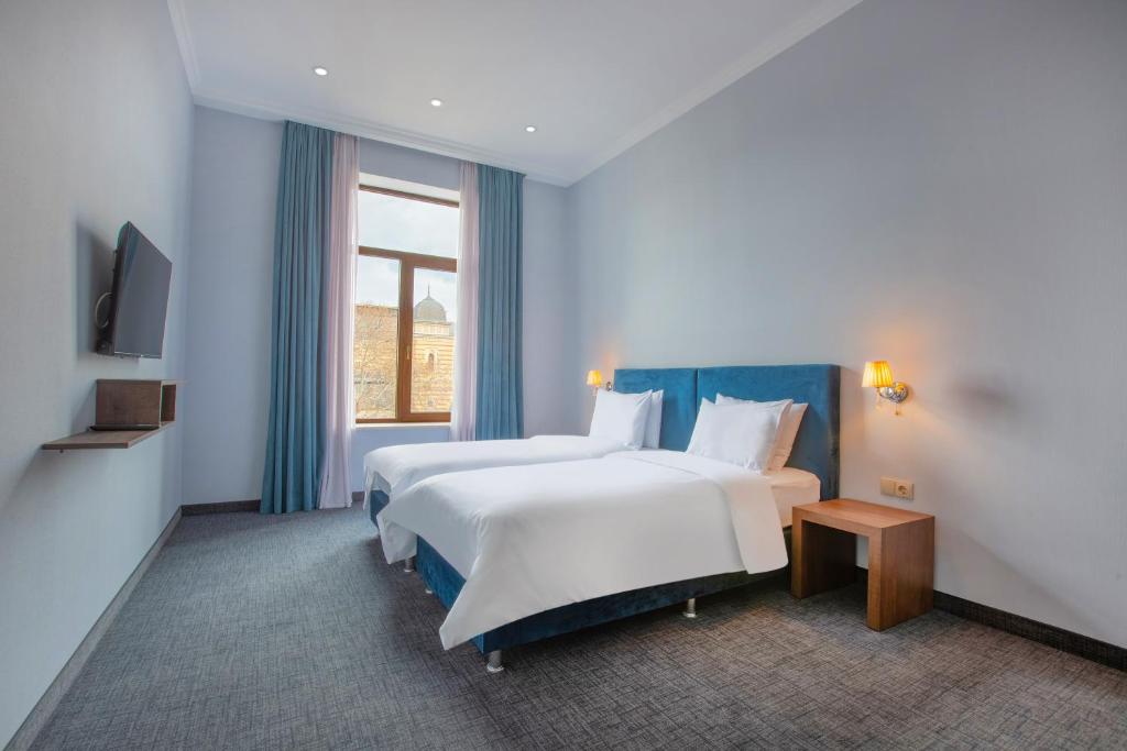 Postel nebo postele na pokoji v ubytování Alma Boutique Hotel