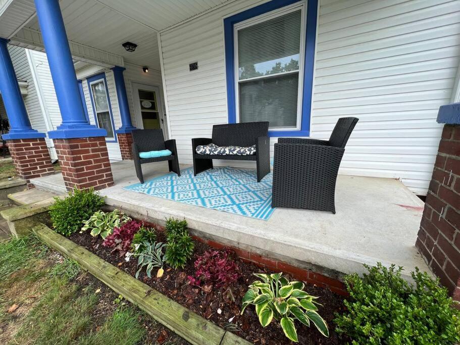 two chairs and a table on the front porch of a house at The Purple Door apt in the heart of Radford city in Radford