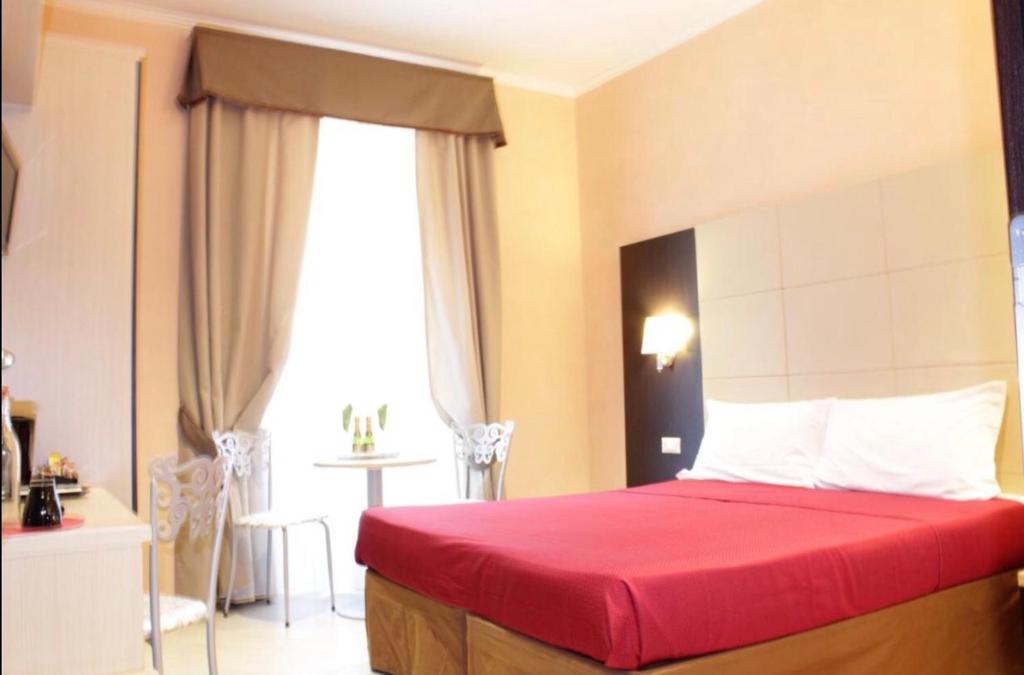Postel nebo postele na pokoji v ubytování Candia Inn Vatican