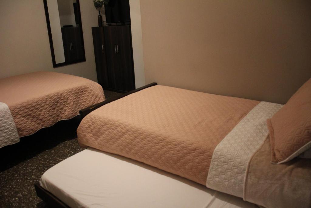 Postel nebo postele na pokoji v ubytování Hotel Plaza El Santuario
