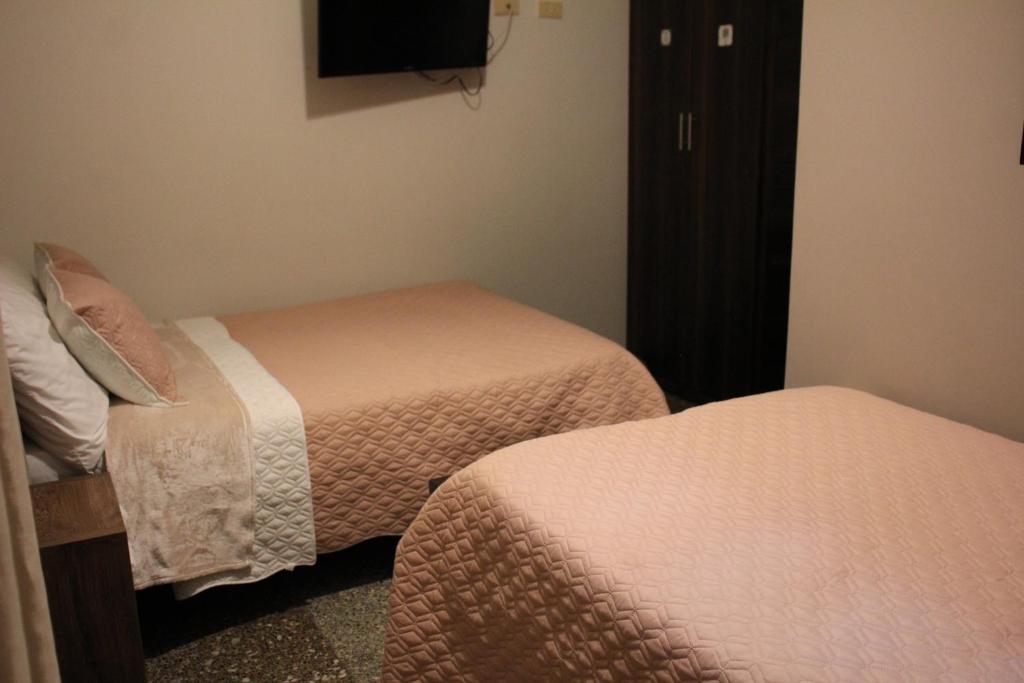 Postel nebo postele na pokoji v ubytování Hotel Plaza El Santuario