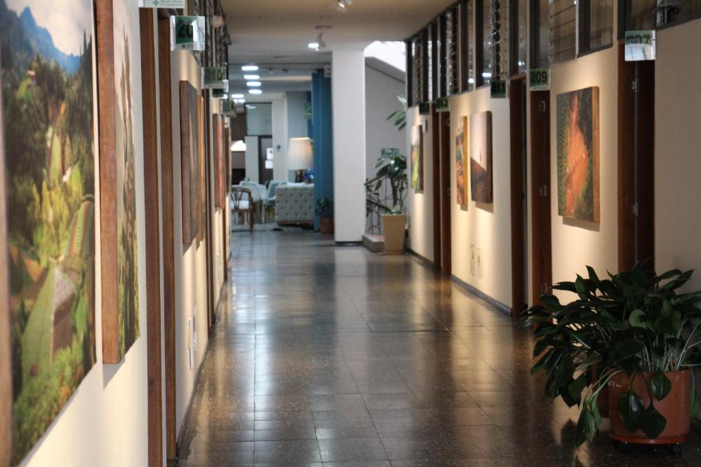 a hallway in a building with paintings on the walls at Hotel Plaza El Santuario in Santuario