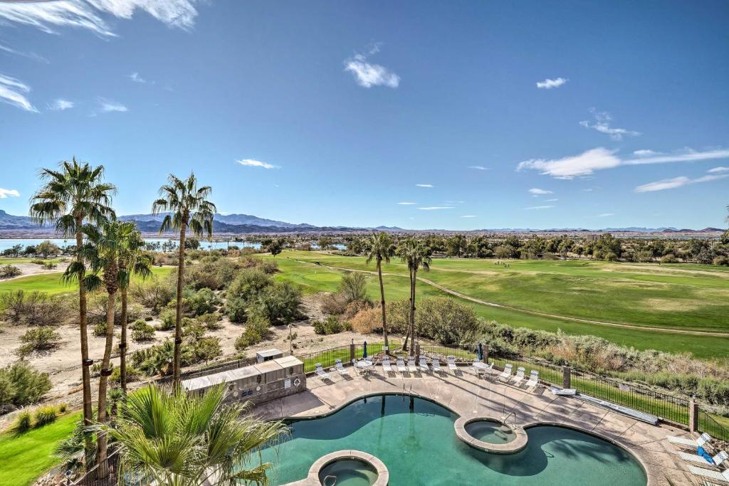 an overhead view of a golf course with a pool and palm trees at Resort-Style Lake Havasu City Condo with Pool! in Lake Havasu City