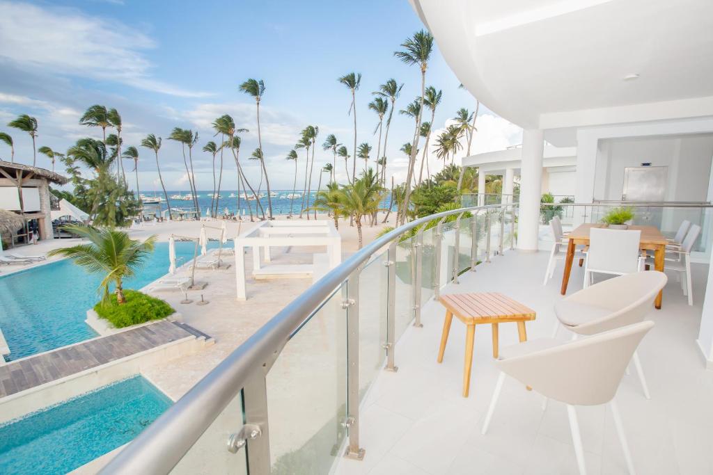 蓬塔卡納的住宿－Destination Jelly / Playa Coral Condo，享有海滩和棕榈树景致的阳台