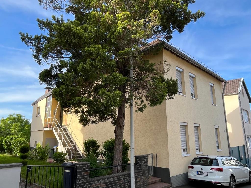 a white car parked in front of a house at Apartment Meditari Bonn-Muffendorf in Bonn