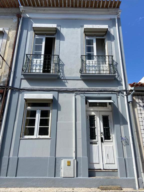 a blue building with windows and balconies on it at Rota Ria Alojamento Local in Aveiro