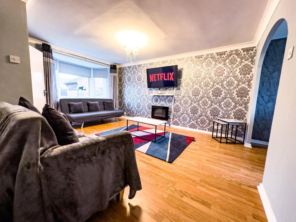 a living room with a couch and a fireplace at The Fairfield - Free Parking & Wi-Fi - 5min to Freeman Hospital in Longbenton