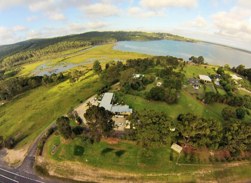 an aerial view of a house on a hill next to a lake at Top of the Lake Holiday Units in Merimbula