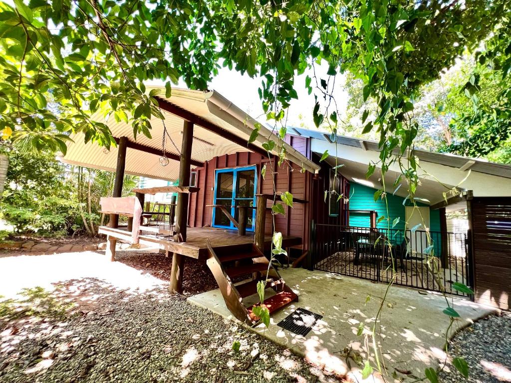 a house with a bench in front of it at Kwila Cottage in Mission Beach